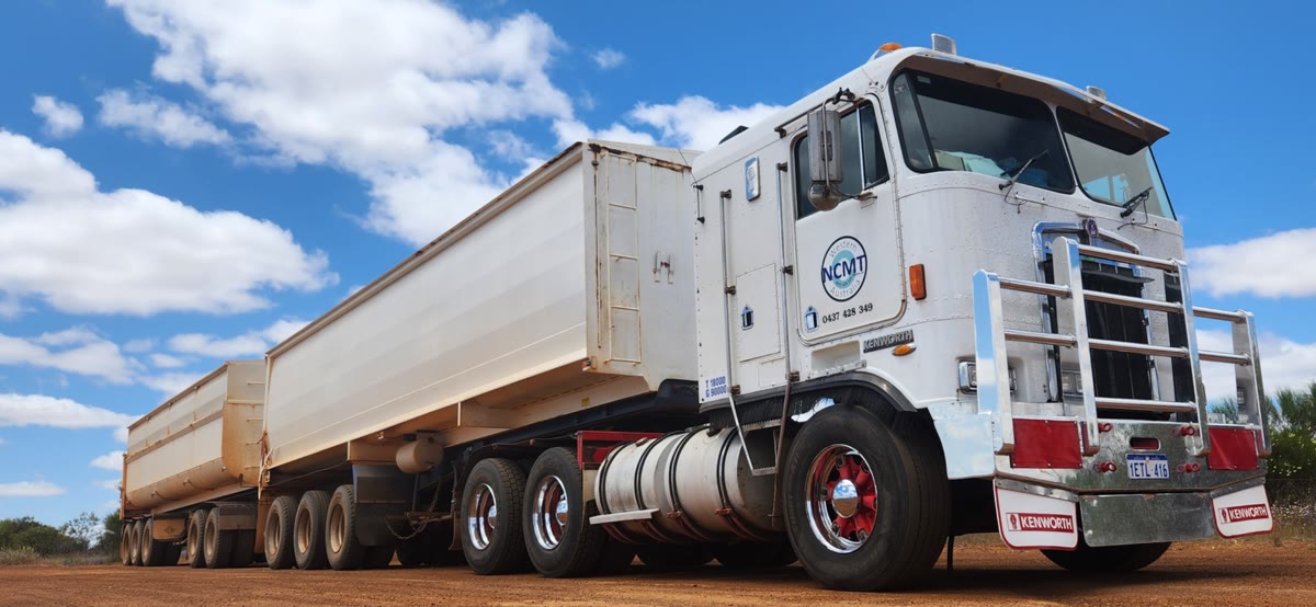 NCMT Kenworth road train with tipper trailers on a red dirt road